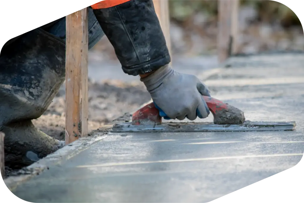 A person smoothing out wet concrete